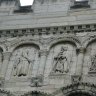 Basilique Saint-Denis - détail de la façade occidentale : bas-reliefs surmontant le deuxième niveau d'arcades du côté gauche (nord). 